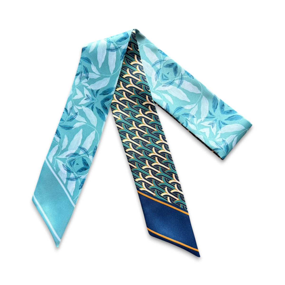Aqua and navy handbag scarf combining delicate blue florals with a sophisticated repeating geometric design.