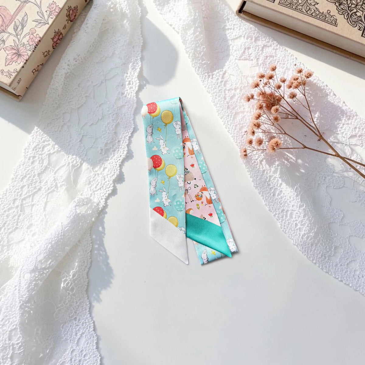 Colourful purse scarf featuring whimsical bunnies and woodland animals with balloons, tiny flowers, and contrasting pastel patterns.