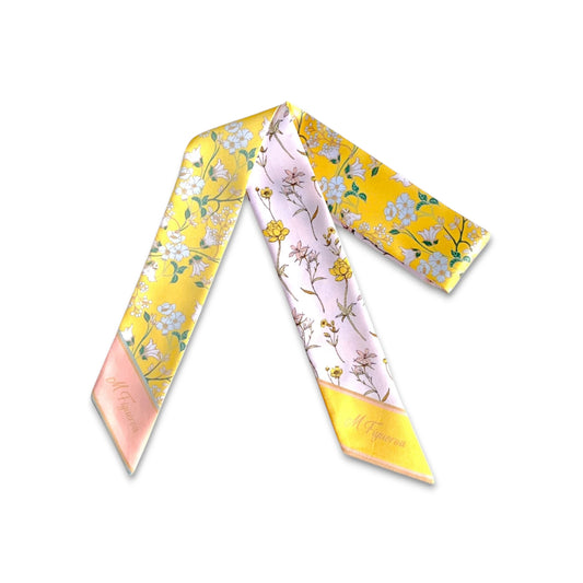 Full view of yellow and blush pink floral twilly scarf with delicate wildflower botanical patterns