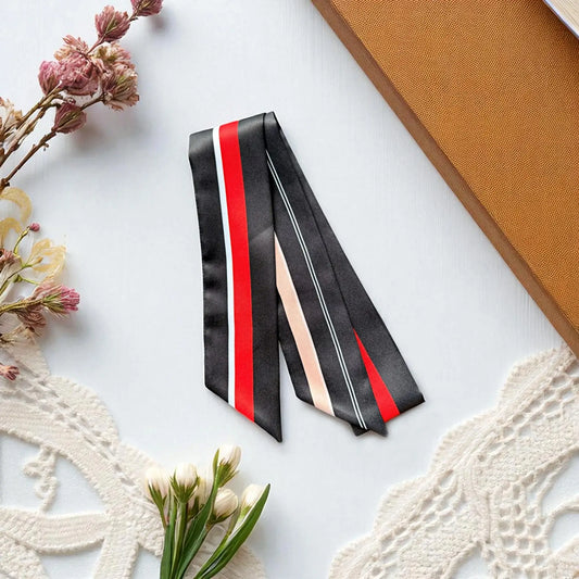 Elegant black satin twilly scarf featuring modern red, white, and beige striped design.