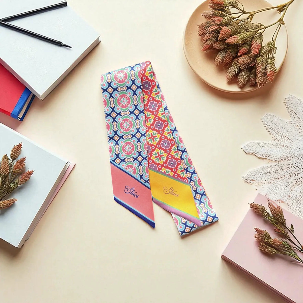 Colourful twilly scarf featuring traditional-inspired repeating motifs with geometric and floral-like details.