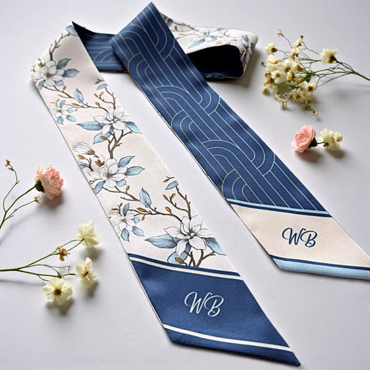 Elegant blue and ivory Twilly scarf with magnolia floral design, geometric reverse side, and personalized initials.