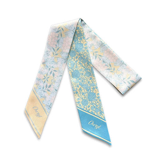 Full view of blue and cream floral twilly scarf featuring contrasting vintage botanical patterns