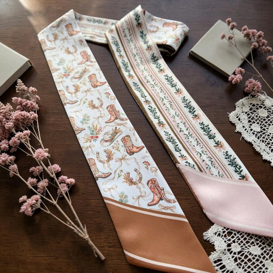 Elegant cowgirl twilly scarf with ornamental floral details and blush pink accents