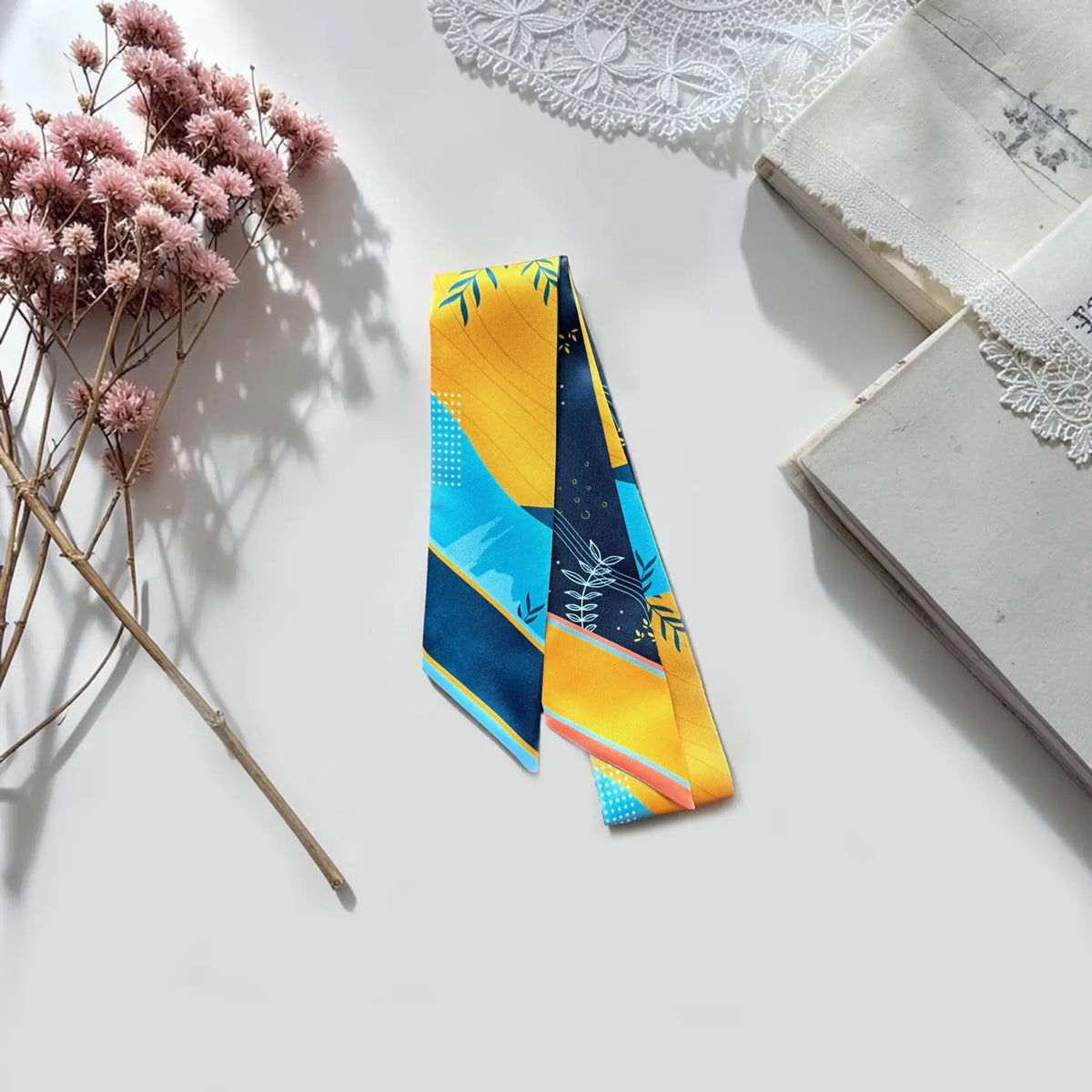 Modern botanical skinny scarf featuring illustrated leaves and geometric colour blocks with personalised name.