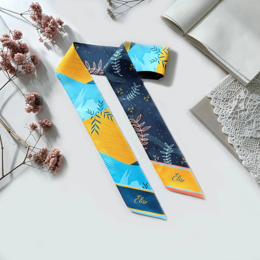 Personalised skinny scarf with navy, turquoise and mustard botanical leaf pattern and custom name.