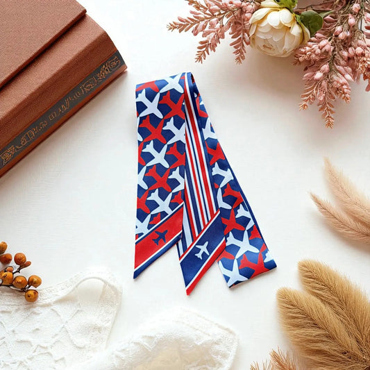 Skinny scarf with airplane print and bold red, white and blue striped pattern in a travel theme