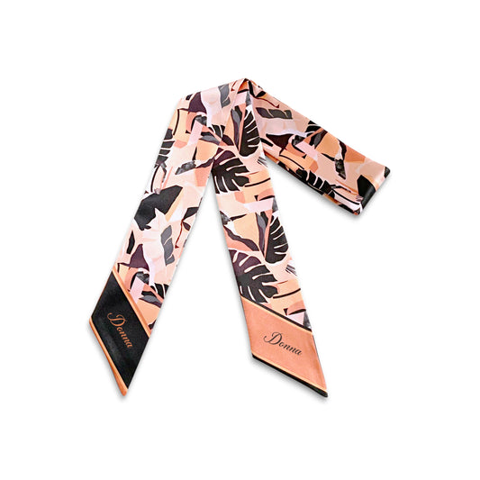 Handmade tropical print handbag scarf in blush peach, coral, and black, featuring modern leaf illustrations and pointed ends with contrasting solid-color borders.