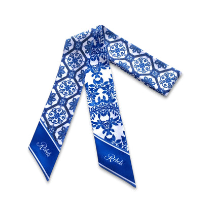 Full view of blue and white twilly scarf with intricate Chinoiserie tile and botanical patterns