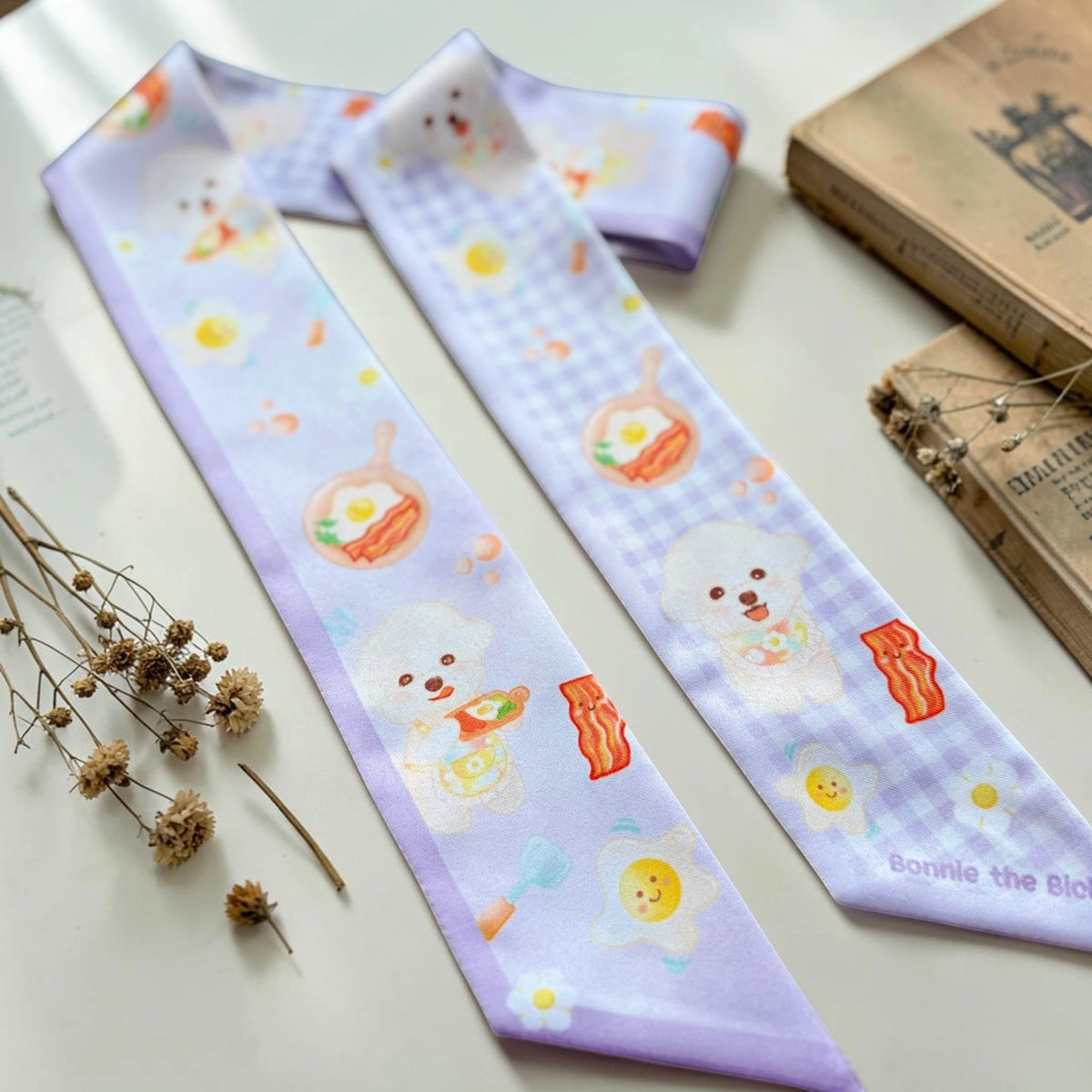 Pastel Bichon breakfast twilly scarf styled with books, dried flowers and lace