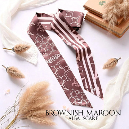 Brownish maroon monochrome skinny scarf featuring soft cream geometric patterns and elegant stripes, styled with dried botanicals and vintage books.
