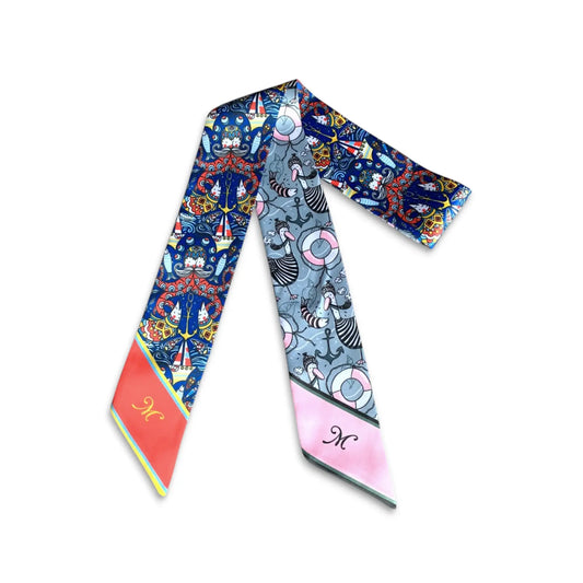 Personalized twilly scarf with playful nautical and sailing motifs in vivid blue, red and pastel tones.