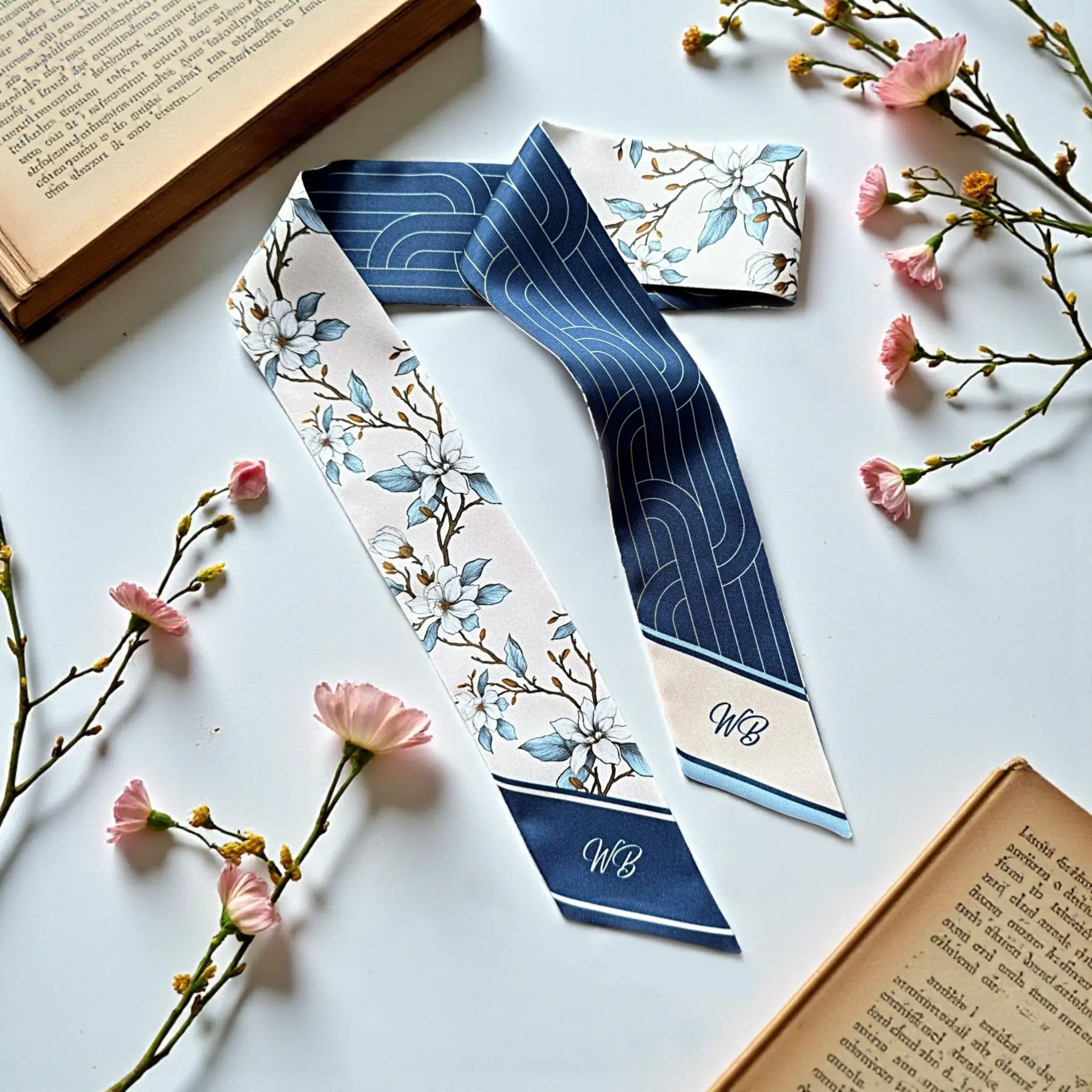 Personalized white and blue floral skinny scarf featuring magnolia blossoms and custom monogram on a luxury skinny handbag scarf.