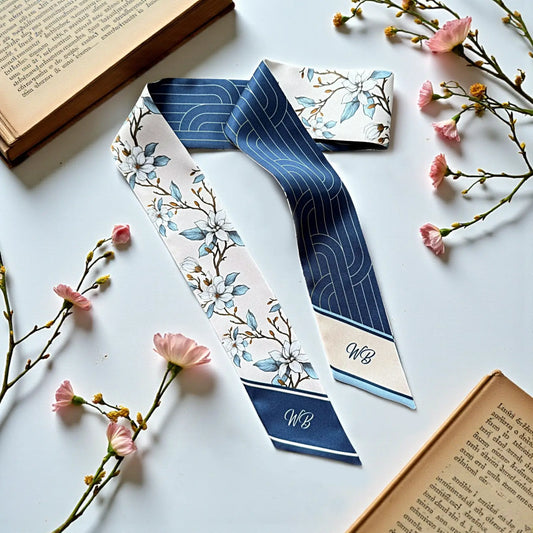 Personalized white and blue floral skinny scarf featuring magnolia blossoms and custom monogram on a luxury skinny handbag scarf.