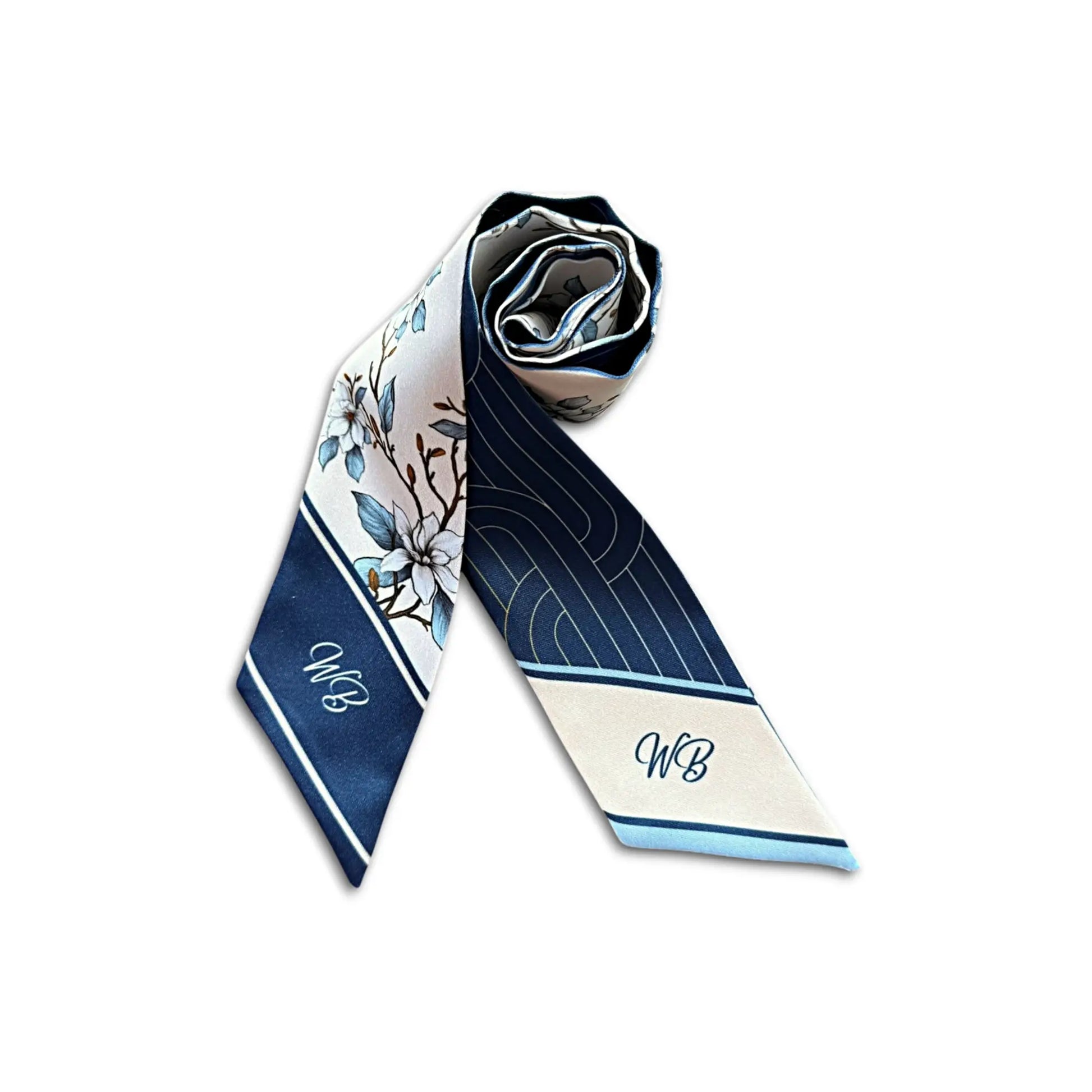 A rolled silk necktie featuring a navy blue and cream floral pattern with monogram initials 'WB' on the ends, displayed on a clean white background.