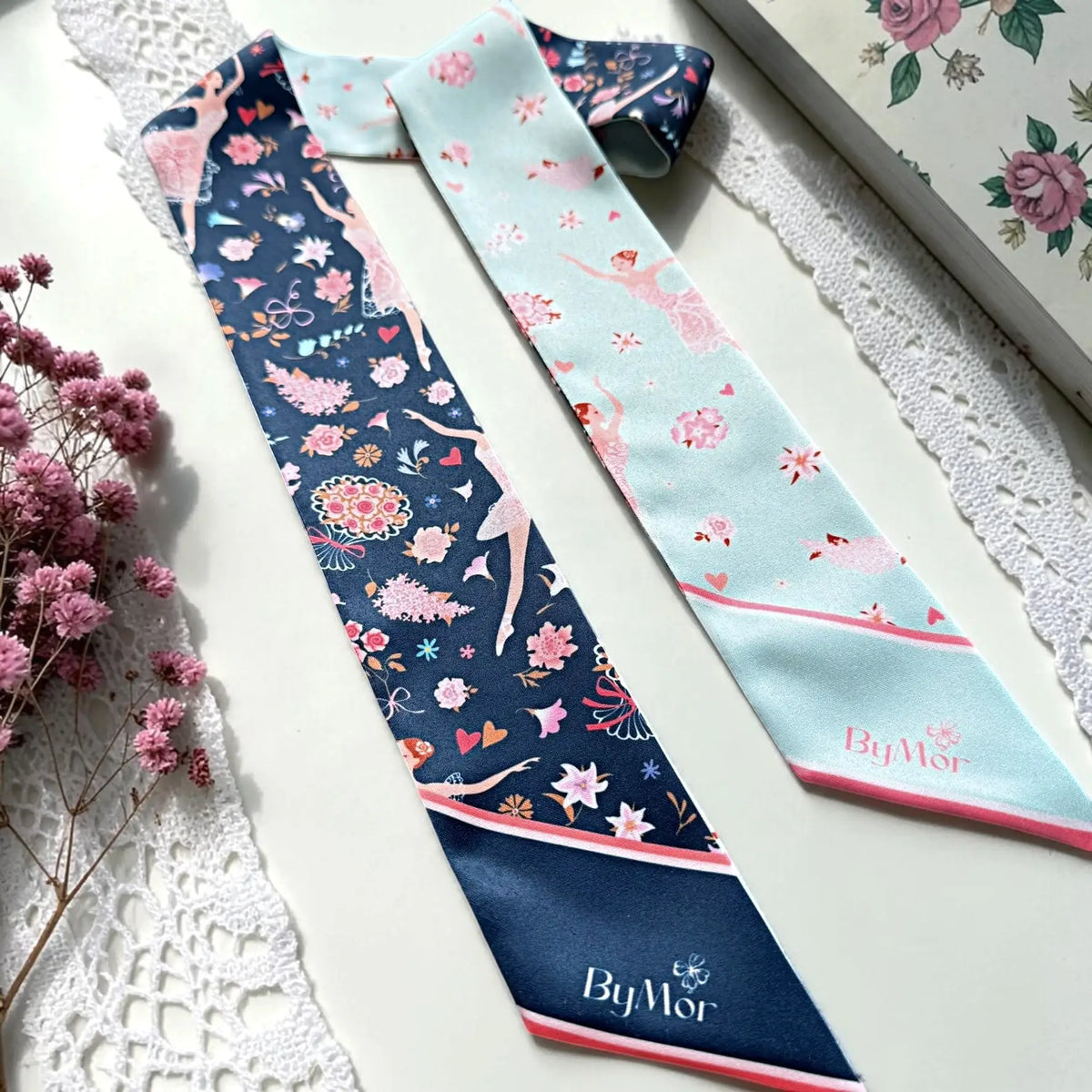 Personalised ballerina handbag scarf featuring custom name Mia on pointed ends, surrounded by pink floral accents and delicate ballet dancer illustrations.