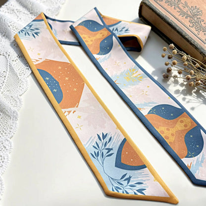 Colorful personalized skinny scarf with custom Molly lettering, featuring artistic orange and blue patterns, delicate floral motifs, and contrasting borders.