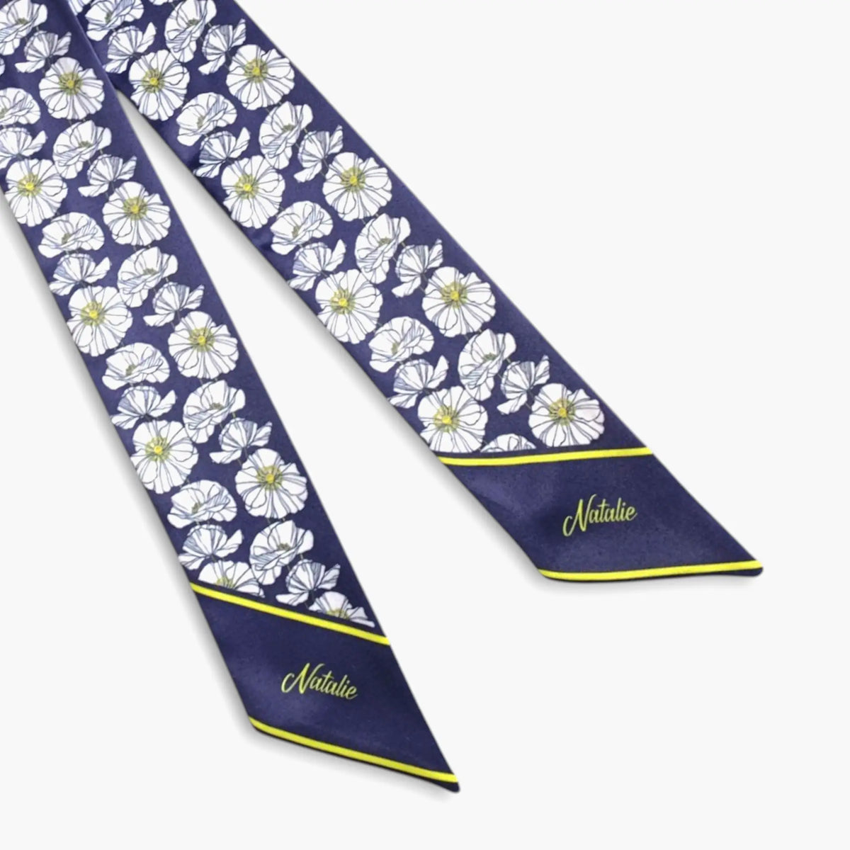 Handmade floral twilly scarf featuring white flowers, navy blue fabric, yellow trim, and custom name embroidery-style printed lettering.