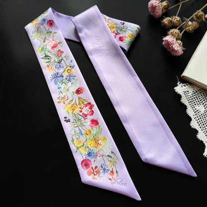 Elegant lilac skinny scarf with vibrant roses, daisies, and garden blooms, featuring a soft purple reverse side.