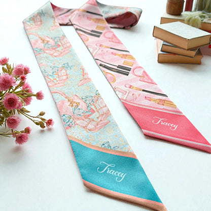 Fashion-themed satin skinny scarf featuring colourful illustrations of lipstick, makeup brushes, handbags, and perfume bottles, ideal as a personalised gift for beauty lovers.