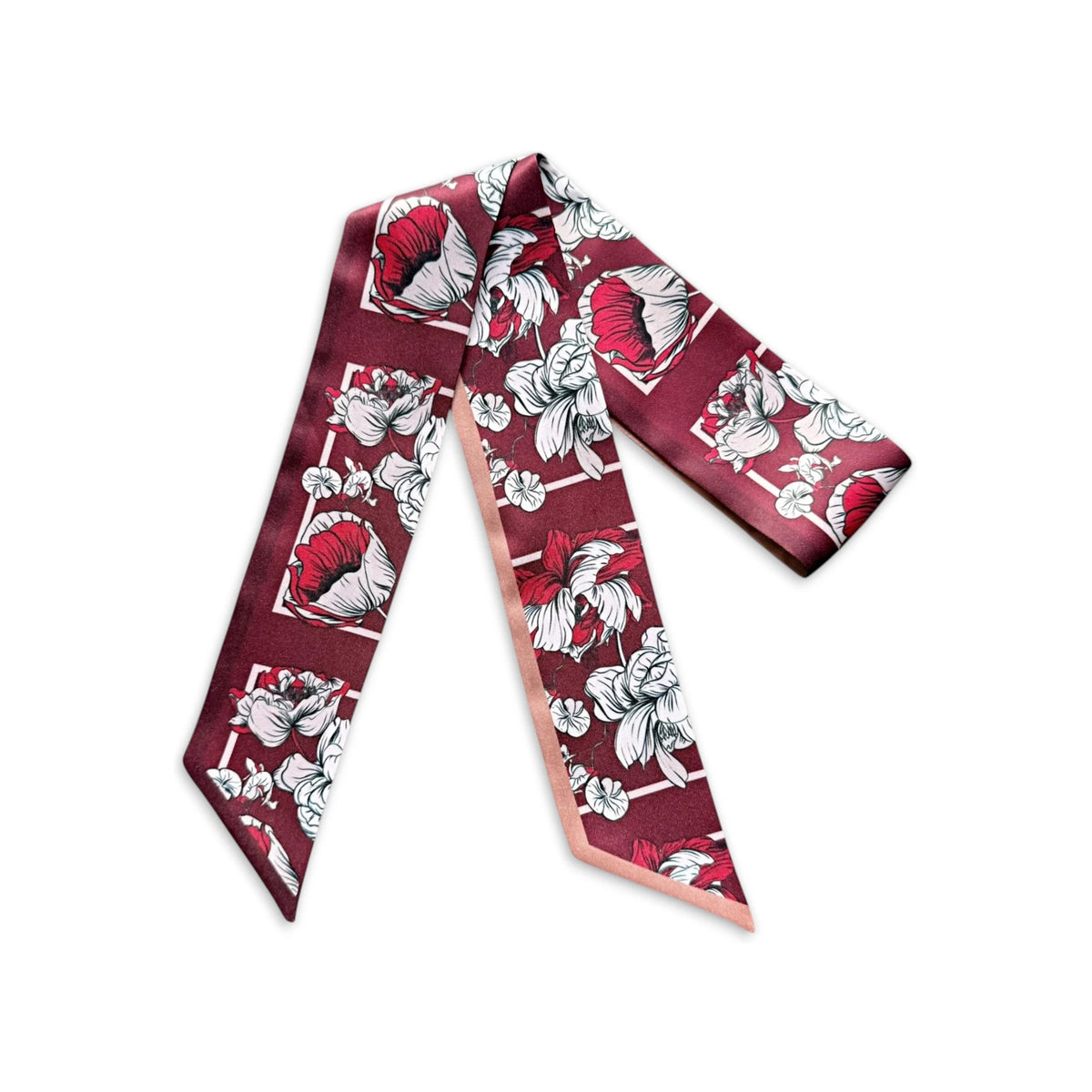 Maroon skinny scarf with bold ivory and pink floral illustrations and a contrasting blush pink reverse side, displayed on a white background.