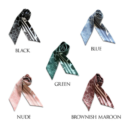 Five monochrome skinny scarves styled with decorative knots, showcasing geometric patterns and striped details in black, dusty blue, deep green, nude pink, and brownish maroon, perfect for personalising handbags and tote bags.
