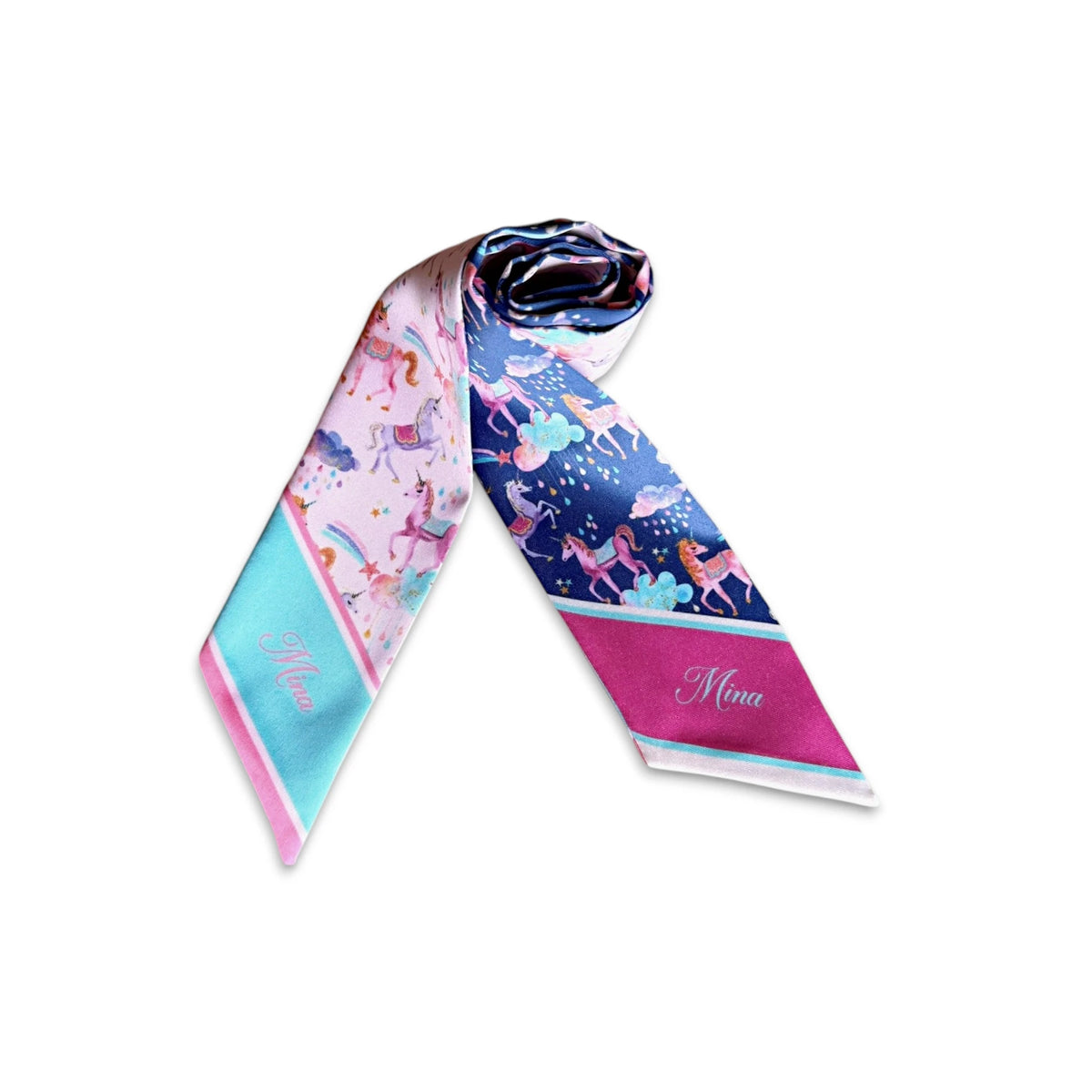 Navy blue skinny scarf with whimsical unicorn illustrations, colourful clouds, scattered stars, and a bright pink custom name tip.