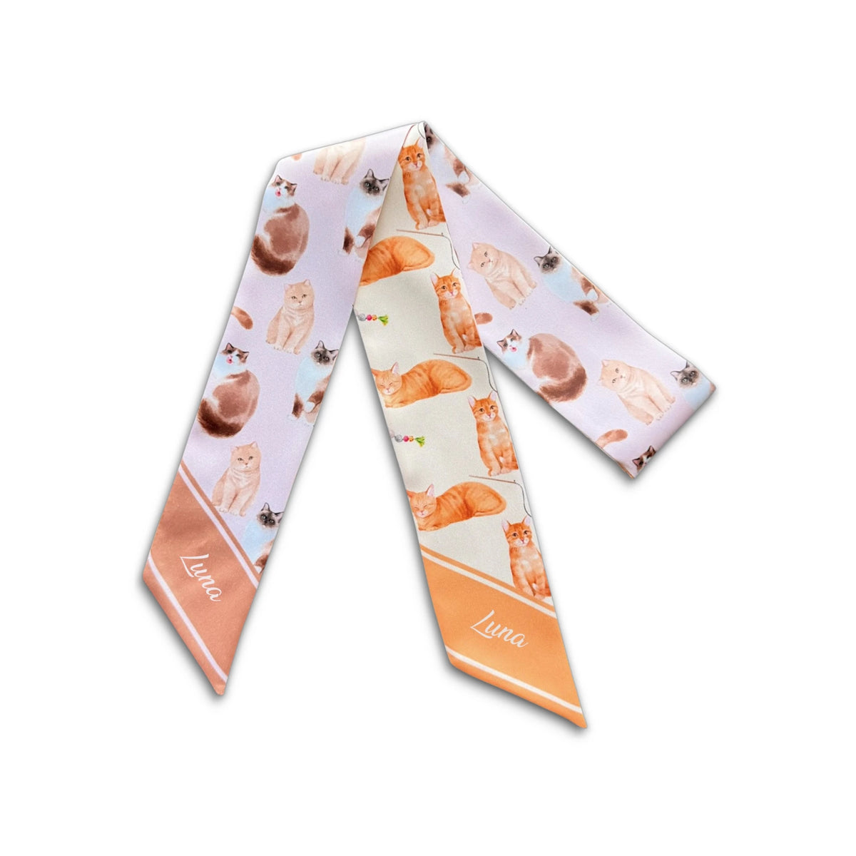 Full product view of a pastel twilly scarf featuring assorted orange, cream and brown cat illustrations.
