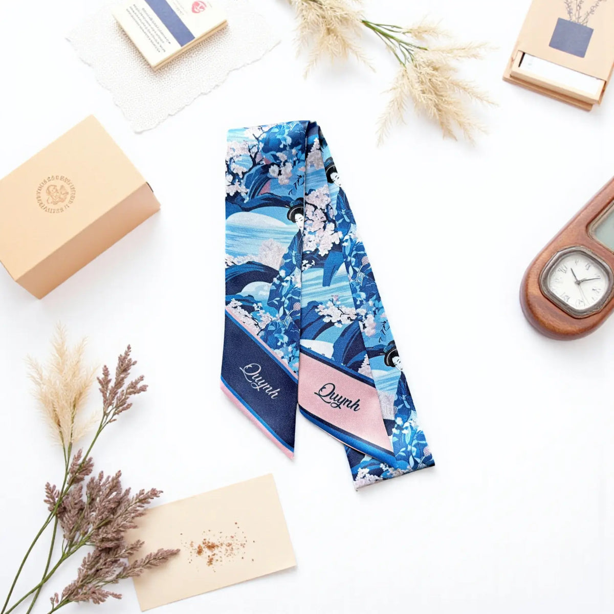 Elegant blue floral purse scarf with cherry blossom illustrations and custom name printing on contrasting pink and navy pointed ends.