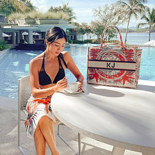 Personalized canvas book tote featuring the Misty Grass tropical botanical design with custom embroidered name.
