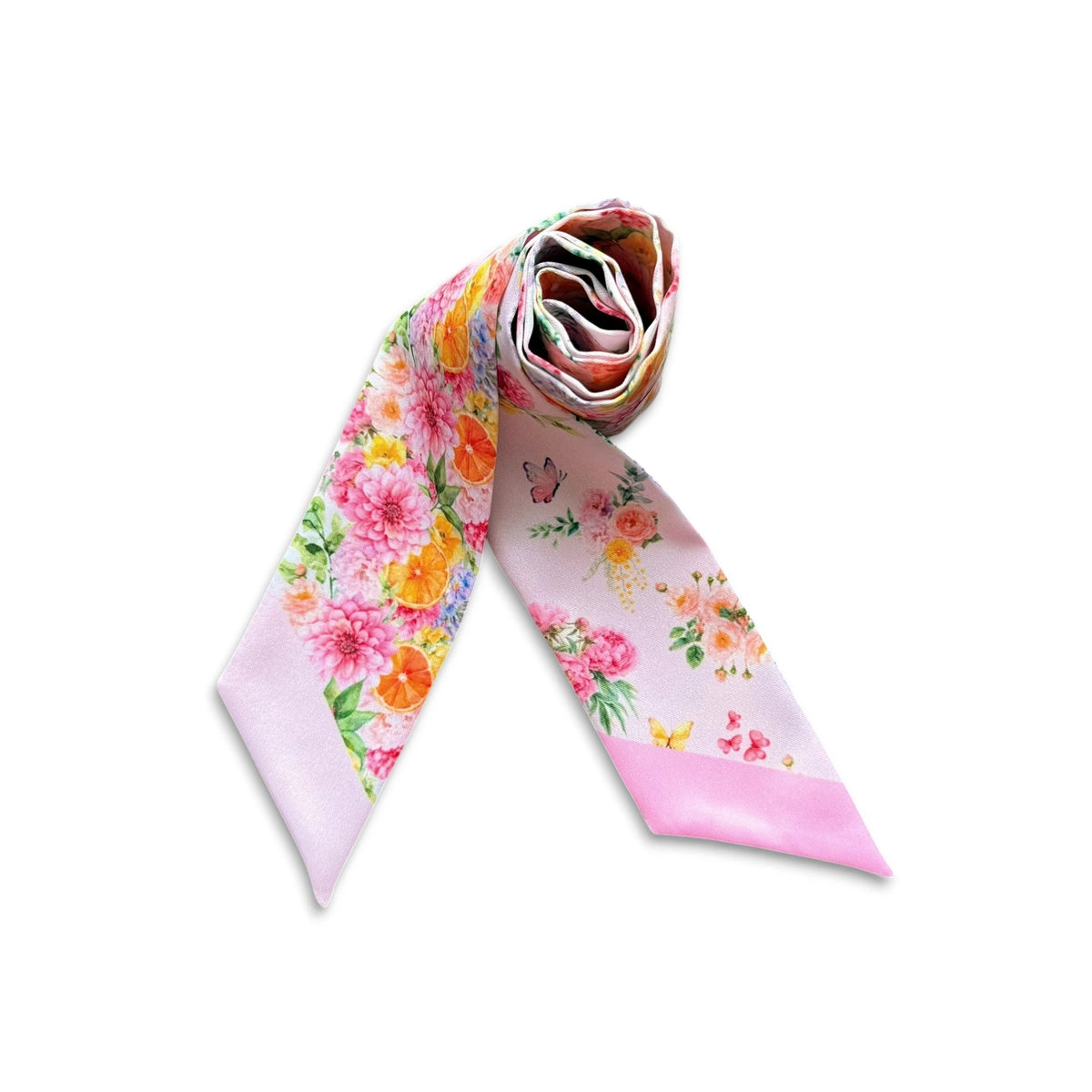 Rolled pink twilly scarf featuring vibrant garden flowers, green foliage, citrus accents and butterflies