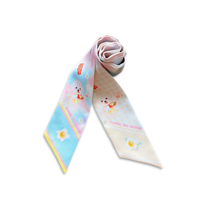 Rolled pastel Bichon dog twilly scarf showing the soft satin finish and breakfast pattern