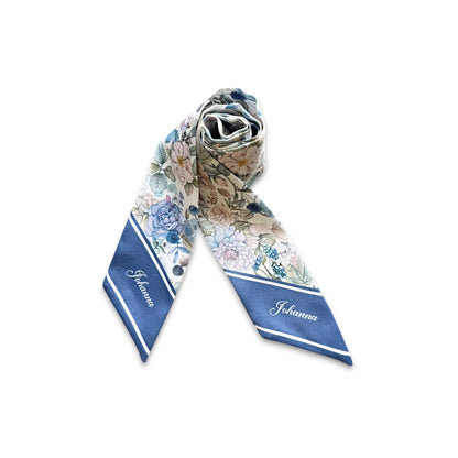 Personalised satin handbag scarf featuring intricate vintage floral motifs in powder blue, blush pink, lavender, and sage green, styled with dried flowers on a clean white background.