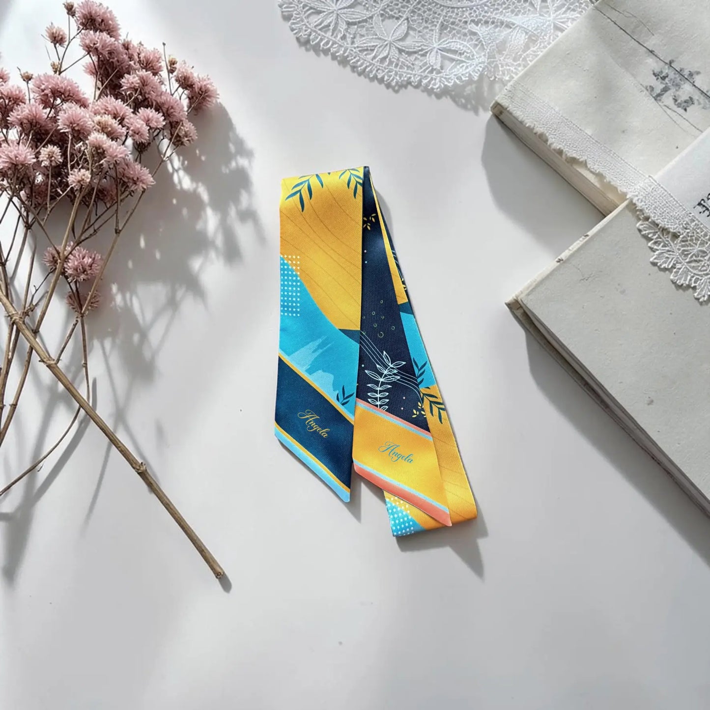 Modern skinny twilly scarf with abstract leaves and geometric shapes in blue and yellow double-sided design