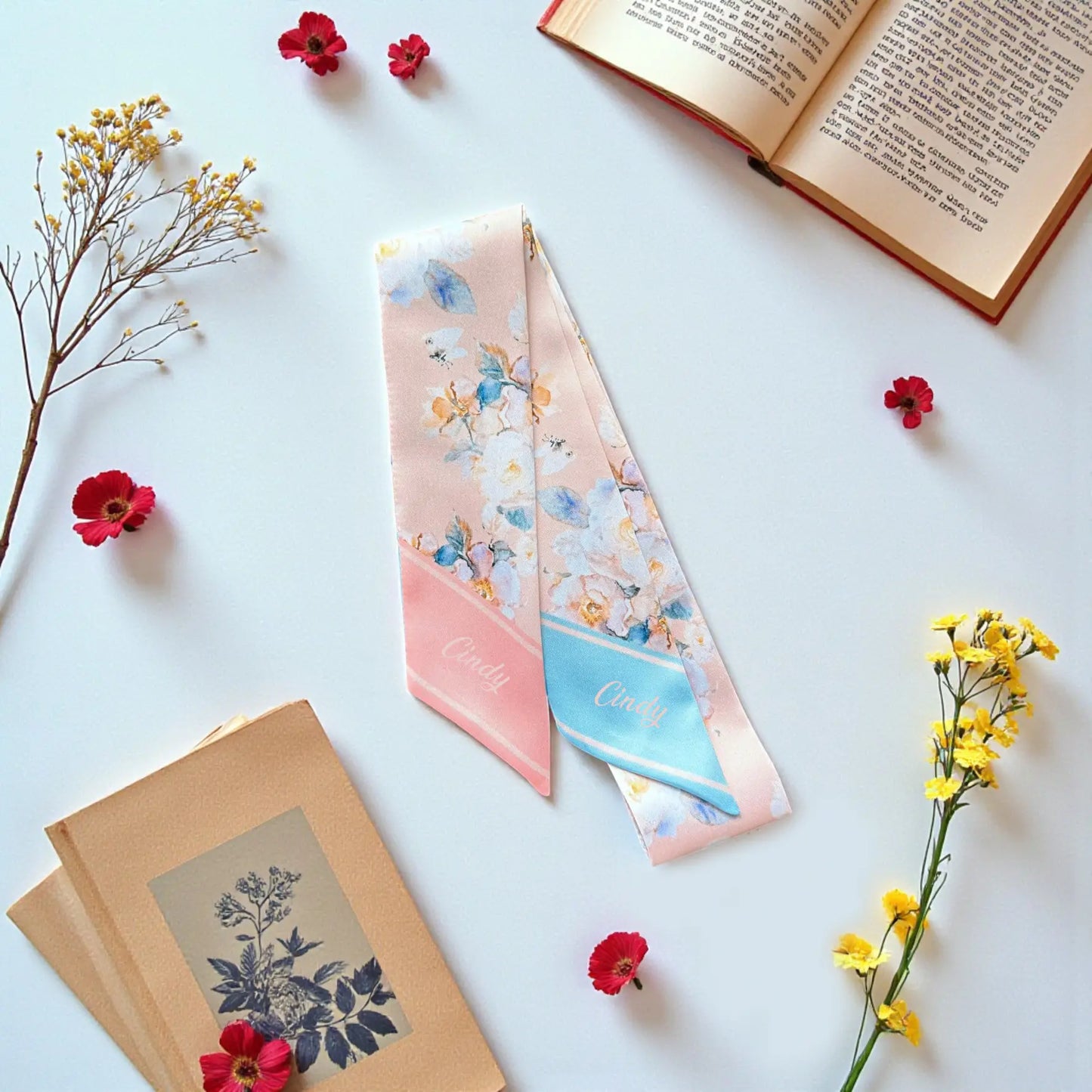 Soft pastel twilly scarf with delicate floral print in blush pink and light blue tones 