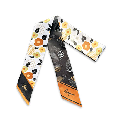 Elegant personalized skinny scarf gift with floral motifs and geometric patterns in brown, black and orange palette