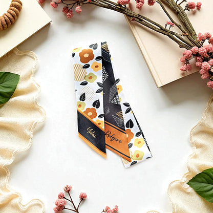 Personalized twilly scarf gift with floral and geometric pattern in warm brown and orange tones, elegant double-sided design