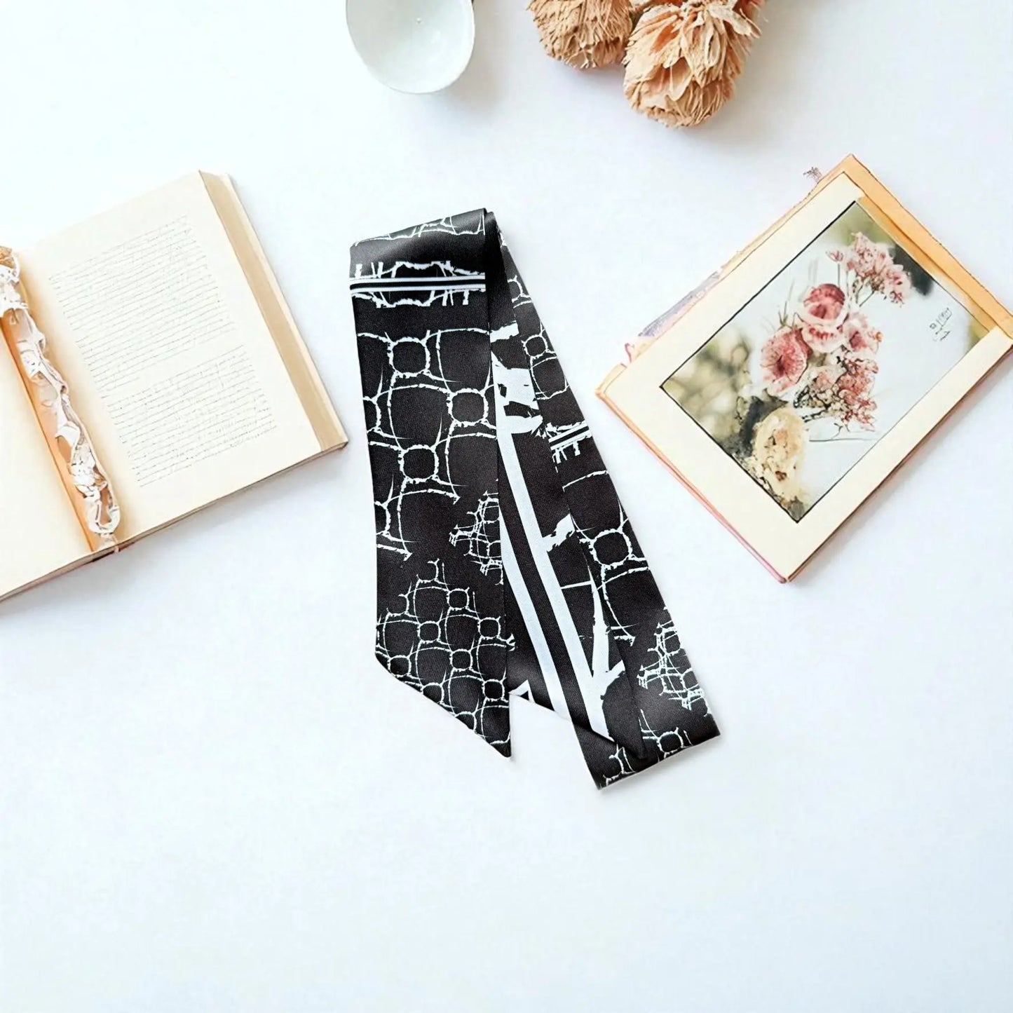 Modern monochrome twilly scarf featuring geometric pattern and striped detail in black and white