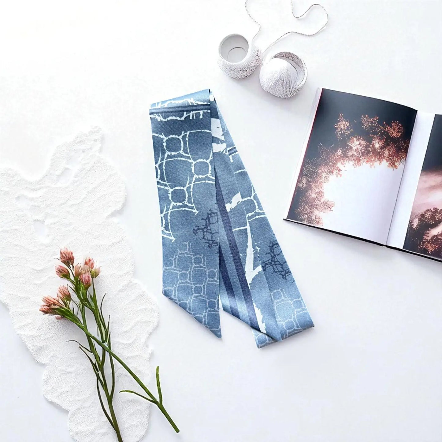 Modern twilly scarf with cool blue tones and clean geometric print in a contemporary design