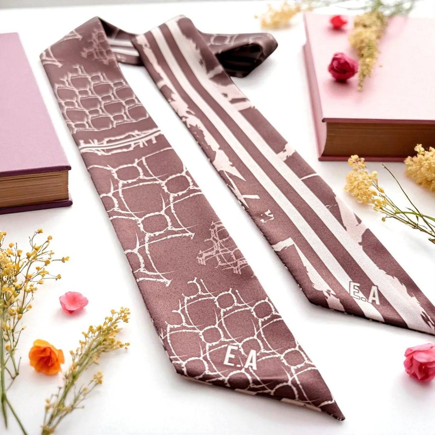 personalized skinny scarf featuring abstract geometric shapes and striped detail in soft maroon tones
