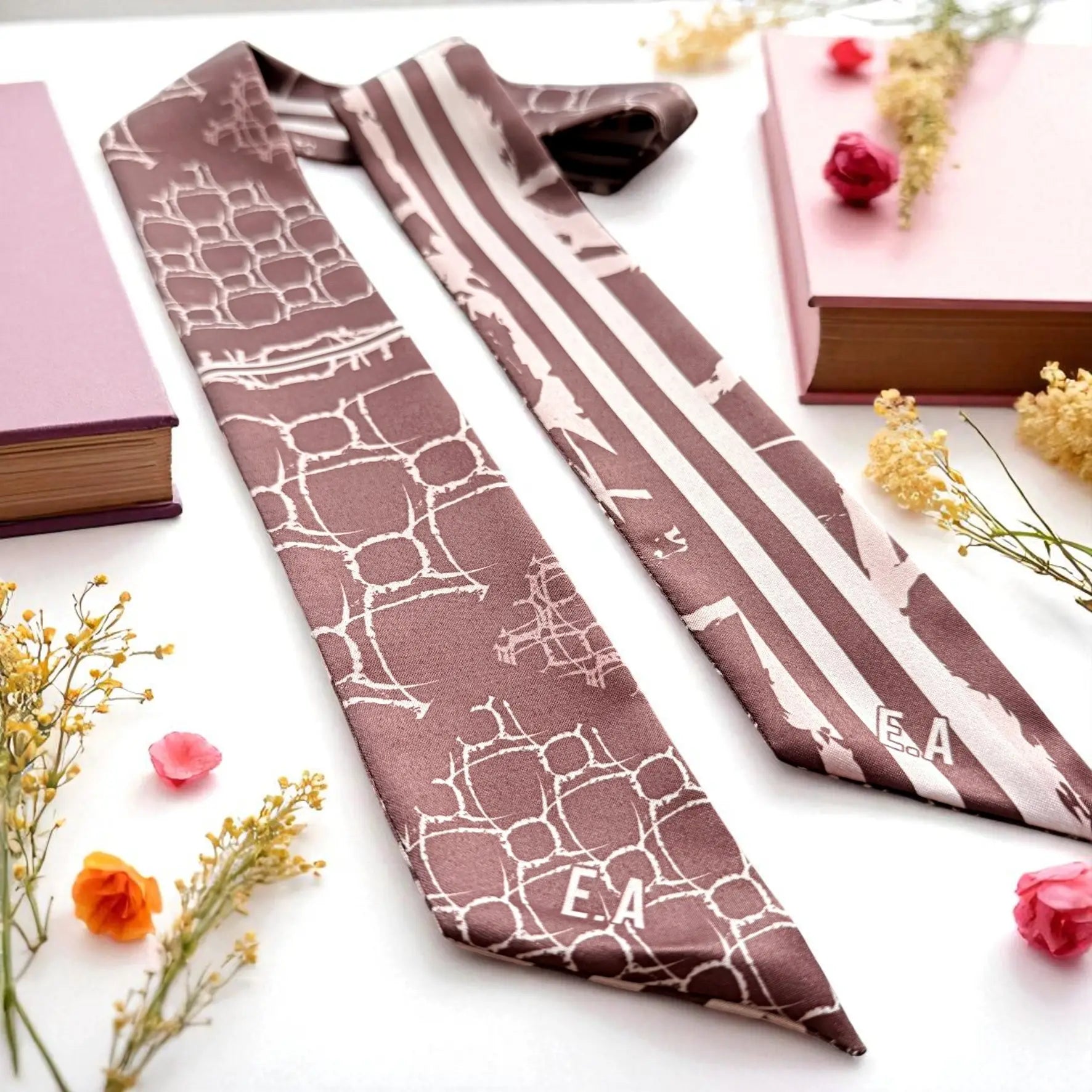 personalized skinny scarf featuring abstract geometric shapes and striped detail in soft maroon tones