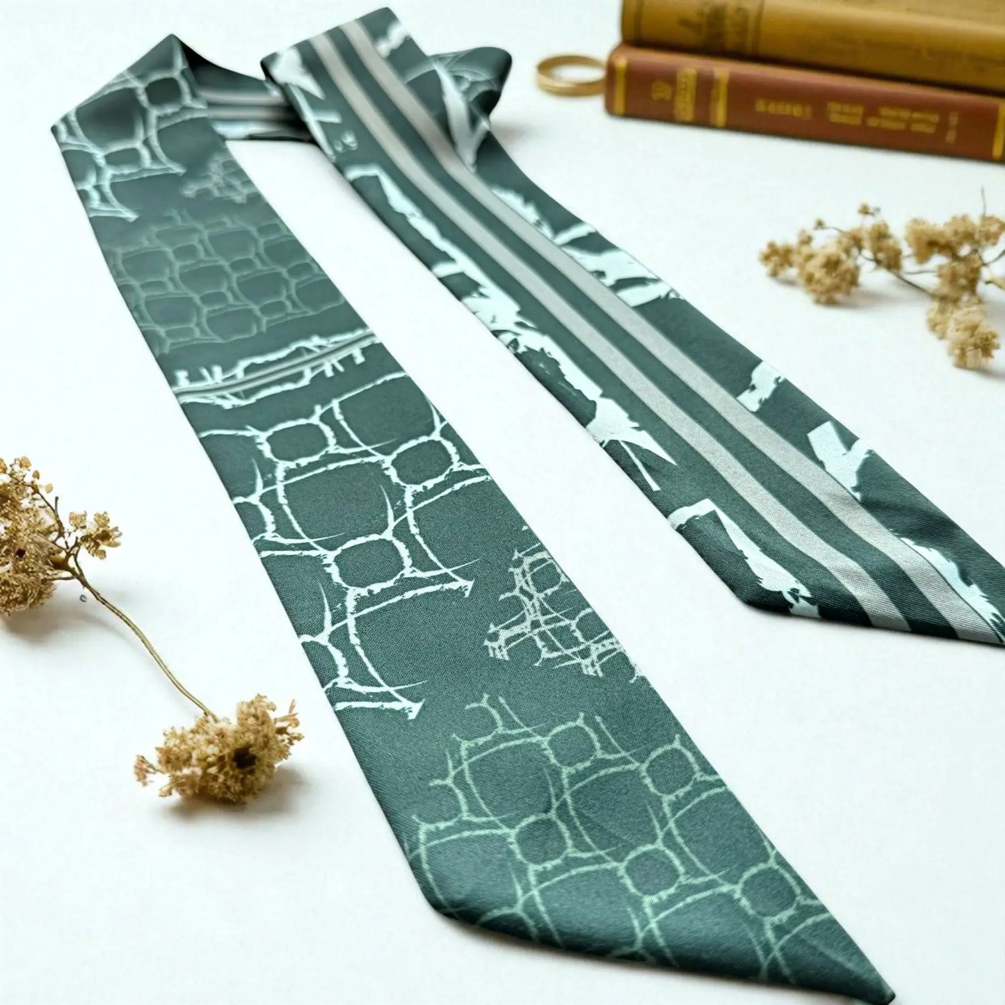 Skinny twilly scarf featuring abstract geometric shapes and stripe accents in rich green colour palette