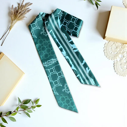 Elegant twilly scarf in deep green tones with subtle geometric pattern and striped detail in a modern design