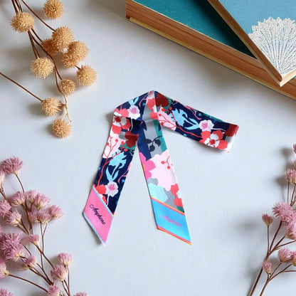 personalized twilly scarf with vibrant floral pattern in pink, blue, and red tones, elegant skinny scarf for bag styling
