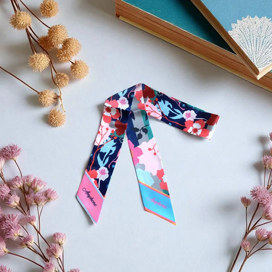 personalized twilly scarf with vibrant floral pattern in pink, blue, and red tones, elegant skinny scarf for bag styling