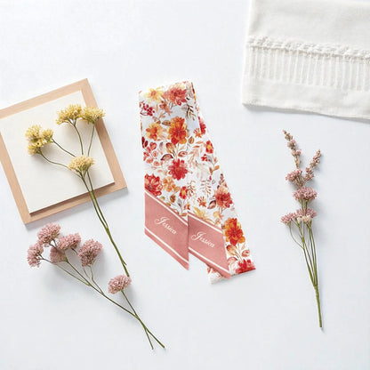 Floral twilly scarf in warm orange and cream tones with soft elegant flower pattern for bag accessory