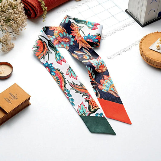 Annika twilly scarf with vibrant tropical floral pattern in multicolor tones, elegant skinny scarf for handbag styling