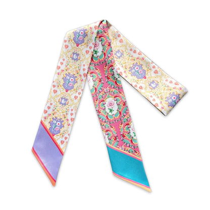 Decorative twilly scarf with intricate baroque ornamental floral motifs in soft pink and gold tones