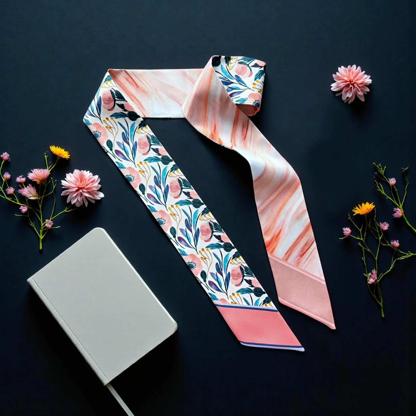 Personalized skinny scarf with delicate floral pattern in soft pink, blue, and peach tones.