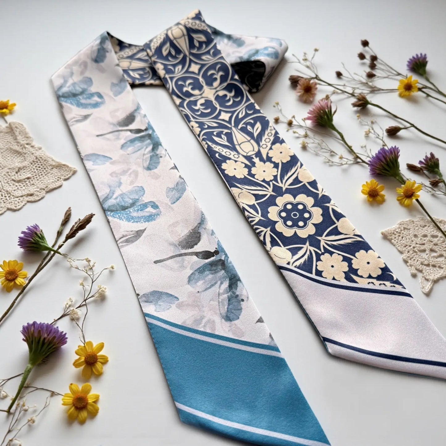 Luxury blue skinny scarf featuring ornate floral motifs and soft watercolor botanical elements, perfect for elegant everyday styling.